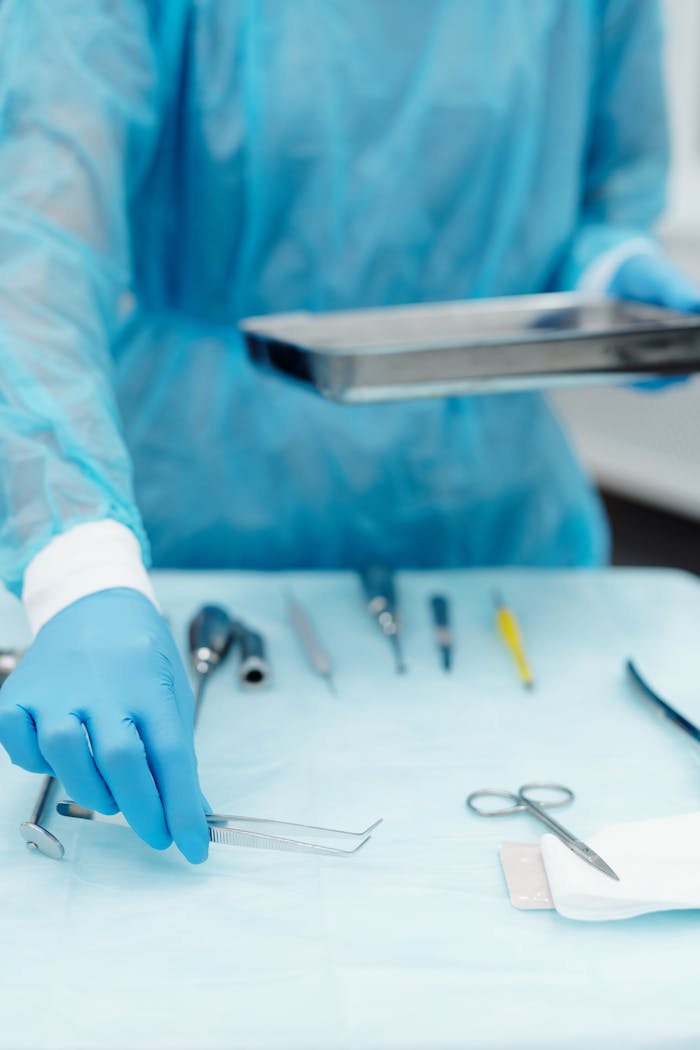 gallery-4 Close-up of a dental professional arranging sterilized tools on a tray in a clinic.