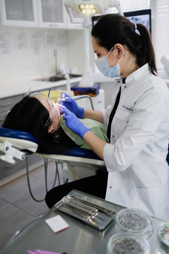 gallery-1 A professional dentist performs an oral hygiene checkup in a modern dental clinic.